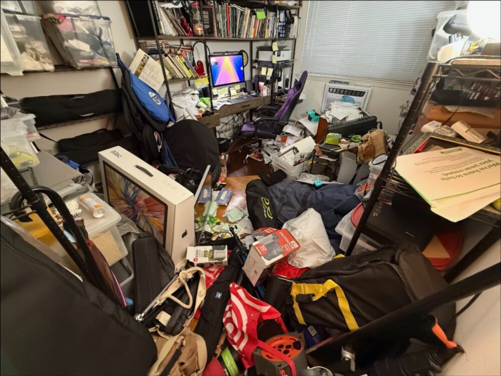 Clutter covering the floor of a Port Washington room before cleanout